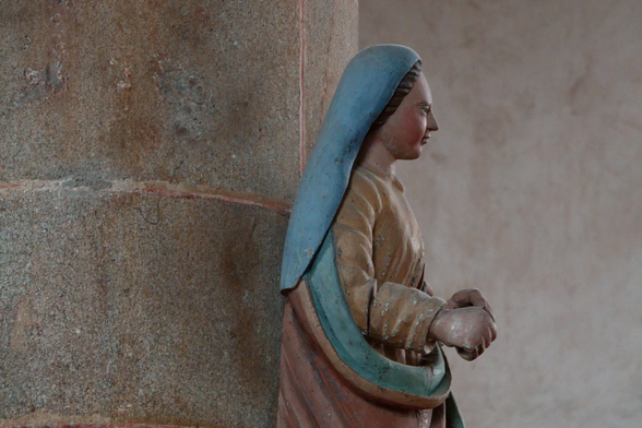 A statue on a pillar in a church
