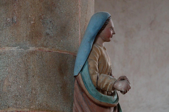 A statue on a pillar in a church