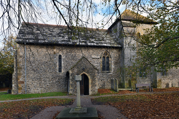 Photo of a Grade 1 listed church dedicated to Julian of Le Mans. Thought to be one of the oldest churches in Sussex, with much of the present building from the C11 and C13. Remains from the earlier Saxon church were discovered in 1964. Flint with sandstone dressings and Horsham slab roof. Kingston Buci, West Sussex, UK.