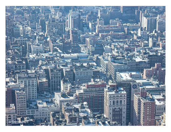 Aerial view of a densely packed urban cityscape with numerous high-rise buildings and rooftops. The image conveys a bustling, metropolitan atmosphere.