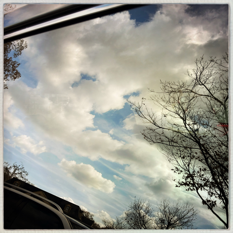 Clouds reflected in a car window