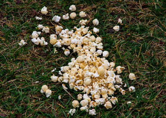 Photo of a popcorn spill seen at an outdoor event.
