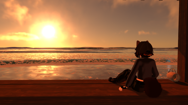 A stylized 3D character with short dark hair, animal ears, and a fluffy tail sits on a wooden pier at sunset, facing the ocean. The character wears dark clothing and a cap, resting one hand on the pier while watching the glowing orange sun sink toward the horizon. The sky and waves are bathed in warm light, reflecting golden tones across the water. A small lantern sits nearby on the wooden boards.