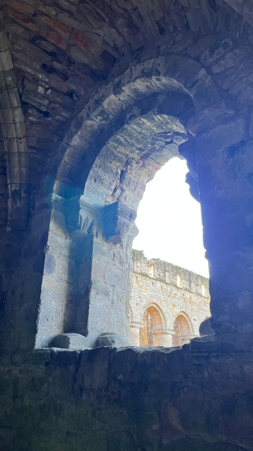 This shot is through the window of the Chapter House, the main church is visible through the window.