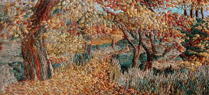 Stitched artwork depicting an autumn woodland with leaf strewn path leading away down the centre. A large tree trunk stands to the left