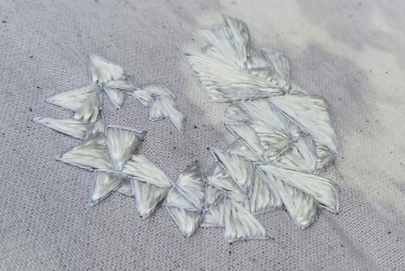 Angled close up of the stitched triangles showing how shiny they are