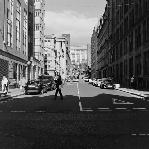 Yashica MAT124G | Kodak Tri-X 400 | Shot at 320 + Med Yellow Filter | Developed in XTOL
Looking up a street, crosswalk in the shadows with a person crossing.