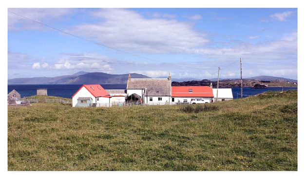 Panoramic colour photograph showing rural properties with the sea and distant hills in the background.