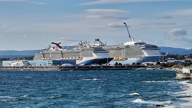 This image shows three cruise ships berthed at Victoria's Ogden Point terminal. The ship in the farthest berth has a ~4000 passenger capacity. The ship in the middle berth has a ~2000 passenger capacity. In contrast, the National Geographic ship in the closest berth has a ~150 passenger capacity.