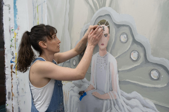 the artist works on a portrait through touch