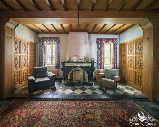 sitting area with fireplace and sofas with black and white checked floor 