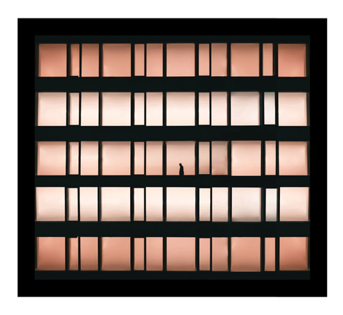 A photo of a silhouette of a person in the middle window of a multi-story building. The windows are arranged in a grid pattern with a gradient of warm, peach-colored glass. The person's silhouette is black against the glowing windows.