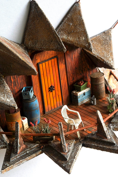 a detail of a hand-sculpted miniature by Simon Laveuve of a small room tableau