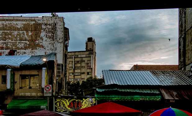 Roofs and facades against the sky at early sunset.