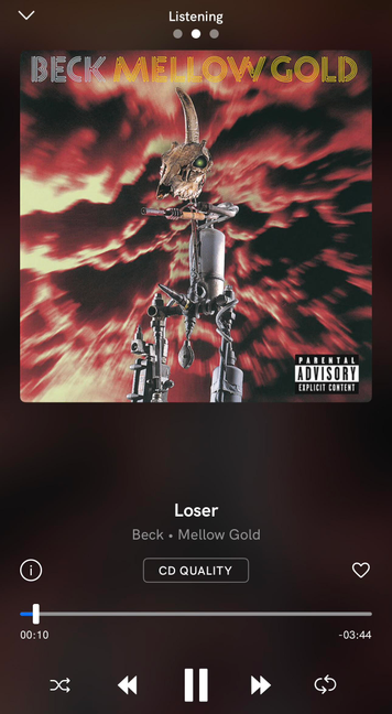 Album art for Beck's "Mellow Gold", featuring a metal figure of an animal skull atop an assemblage of metal pipes and other parts, set against a red-tinged, cloudy background; the image also includes "PARENTAL ADVISORY EXPLICIT CONTENT". The image is shown within a music player interface; the song title "Loser" is displayed below the album art, as are the artist and album name "Beck • Mellow Gold." Additional controls such as play/pause, skip, shuffle and like buttons are shown, alongside song timing.