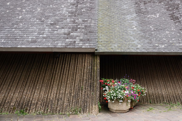 A big flower pot in front of a church