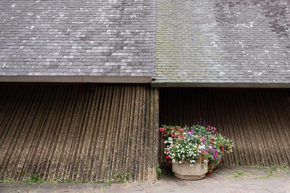 A flower pot in front of a church