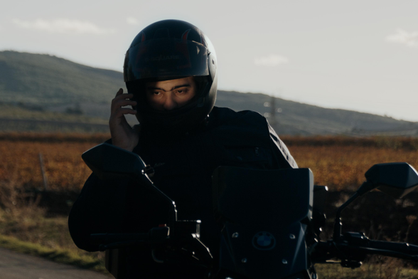 A pause in motion—connection made mid-journey, framed by hills and golden light.