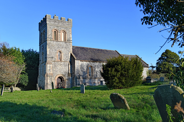 Photo of the parish church at Falmer rebuilt c.1815 in a Norman Revival style, using knapped flint with stone and brick dressings. Architect not known. Remodelled some time in the mid-C19. Grade 2* listed as the 'Parish Church of St Lawrence'. East Street, Falmer, Sussex, UK.