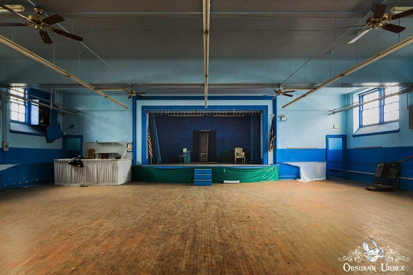 Hall with wooden stage and a blue stage