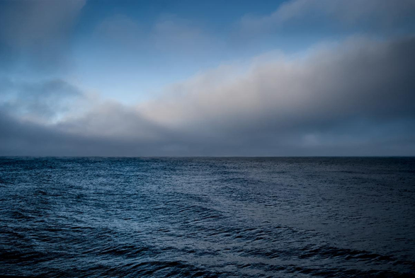 The Baltic Sea at dusk, at the end of November. The photo shows the empty sea, the horizon, and the sky with blurred clouds.