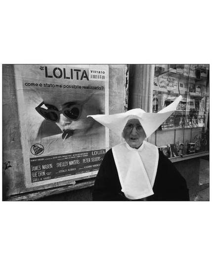 BW pic of a nun near a poster of Lolita movie.