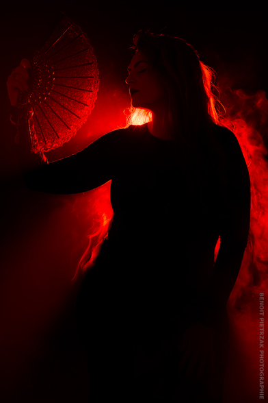Photograph of a woman in a studio, photograph with red light