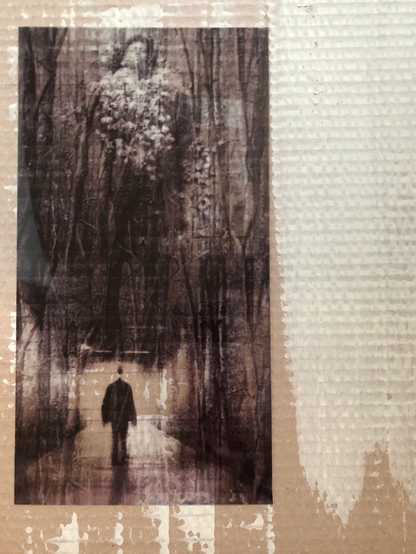 Painted cardboard, vertical photo of a man in a wooden tunnel.