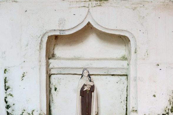 a small figure in a niche