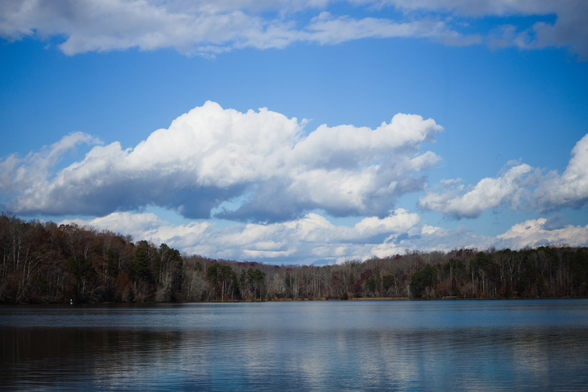 There's a... liminal-ness to this that I can't quite place. It's like I'm looking into something that isn't real, but is real. I think it's how I tuned the sky. It looks like a fever dream, in a Vivarium kind of way.
Clouds over Salem Lake, fall trees in the background.