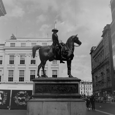 Yashica MAT124G | Kodak Tri-X 400 | Shot at 320 + Med Yellow Filter | Developed in XTOL

A statue of a man on a horse, with a road cone on the man’s head