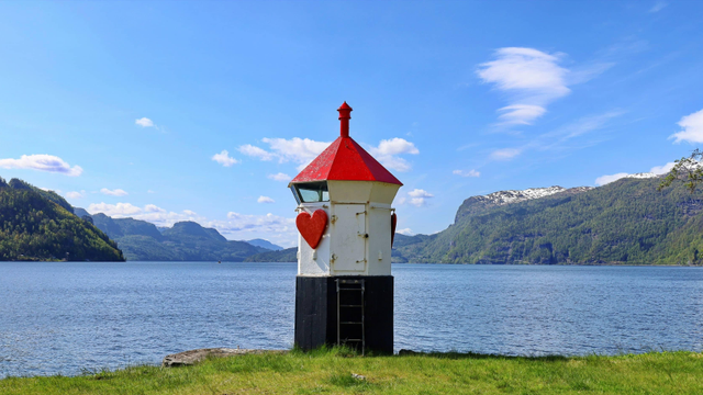 'A beacon of love'
A heart-adorned lighthouse rises at the edge of Sauda Fjord, Norway, its red roof gleaming against the serenity of the blue sky and mountains steeped in green. 
Photograph by Mark König