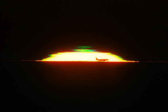 As the evening Sun fades from the viewpoint on Cerro Pachón, a green light peeks through. This phenomenon is known as a green flash, or green rim. The green is a result of atmospheric refraction as the Earth’s atmosphere separates white sunlight into its constituent wavelengths. Although a green rim is present at every sunset, there’s a good chance that you’ve never noticed it! It’s too thin to be seen by the naked eye, and only lasts a handful of seconds as the Sun slips past the horizon. Photography and videography are the best ways to capture the rare appearance of this atmospheric effect. While not a natural phenomenon, this image also serendipitously captures a soaring airplane against the fading sunlight.

This sunset was captured from Cerro Pachón in the Chilean Andes. Cerro Pachón is home to several telescopes operated by NOIRLab including the SOAR Telescope, a part of the U.S. National Science Foundation (NSF) Cerro Tololo Inter-American Observatory (CTIO), a Program of NSF NOIRLab; Gemini South, one half of the International Gemini Observatory, funded in part by the NSF; and NSF–DOE Vera C. Rubin Observatory, which is jointly funded by the NSF and the U.S. Department of Energy Office of Science (DOE/SC).

Petr Horálek, the photographer, is a NOIRLab Audiovisual Ambassador.

Credit: NOIRLab/NSF/AURA/P. Horálek (Institute of Physics in Opava)
