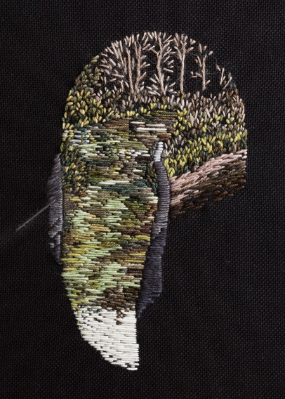 Stitched artwork depicting the view through a canal tunnel. The fabric is black and the darkness in the tunnel is represented by negative space. Trees in the distance are reflected in the water. A towpath and railing are to the right