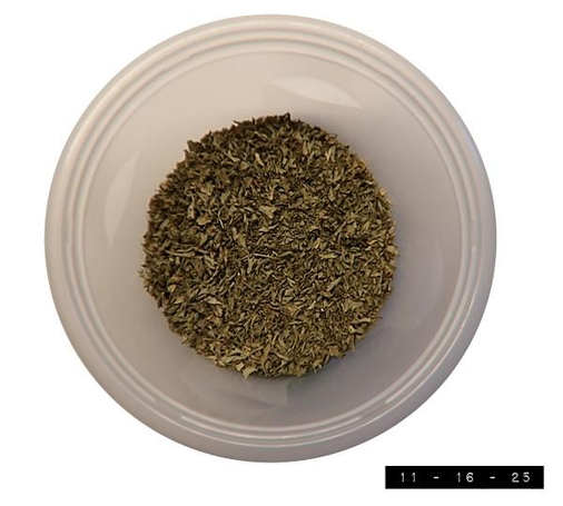 Top view of an opaque plastic storage container with its blue plastic lid off.  The container is about 5.75" in diameter.  Inside it is a fair amount of chopped and dried parsley.  I do not know how old this parsley is.  It could be a year old.  It could be ten years old.  Maybe twenty.  Probably not thirty, but I wouldn't bet on it.  All I know is that I like it much better in my spaghetti sauce than gold, frankincense, or myrrh.  (Making a note of this in case I'm ever tempted to take a gift to a new-born messiah and there isn't time to buy some Lego bricks.)    