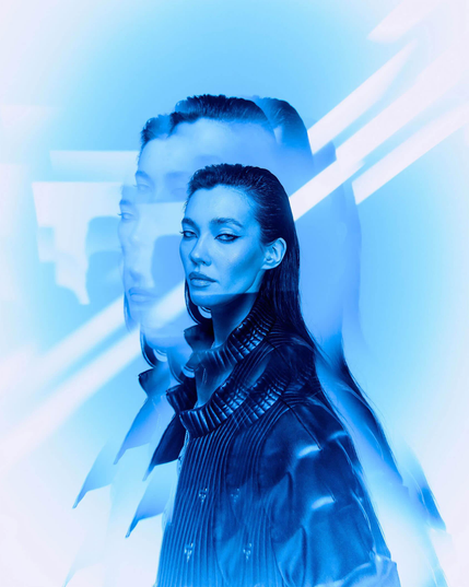 A stylized portrait of a person in a sleek jacket, surrounded by a blue glow and ethereal light streaks, conveying a sense of mystery.