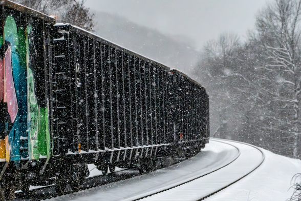 A train stopped on in the snow on snow covered tracks