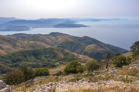 Sunny view of the mountains with serpentines and sea bays.