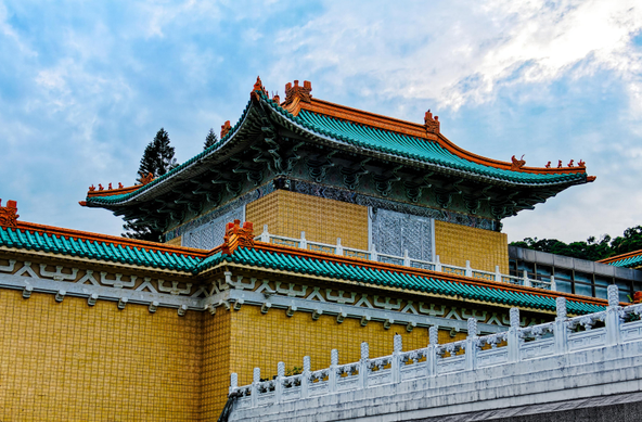 Palace side building with doors and windows closed and an overpass in front.