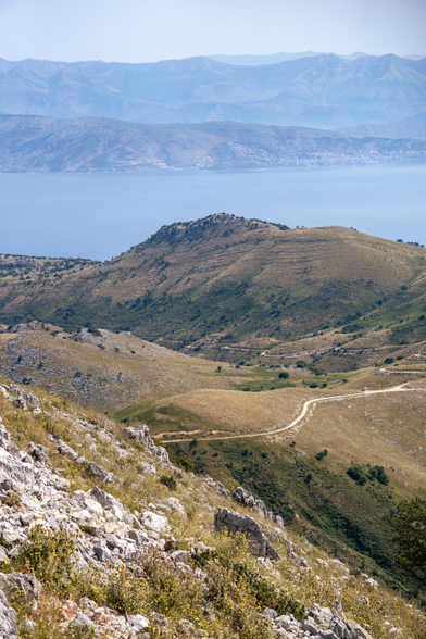 Sunny view of the mountains with serpentines and sea bays.