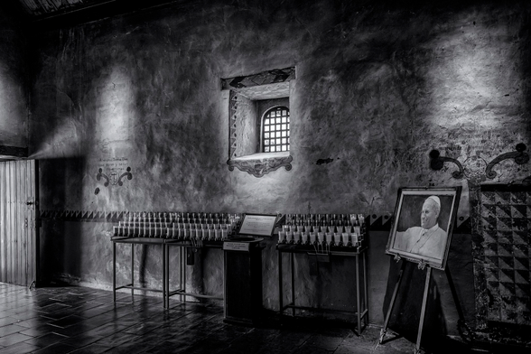 Another view of the votive candle area with a photograph of Pope John Paul who visited the Mission.