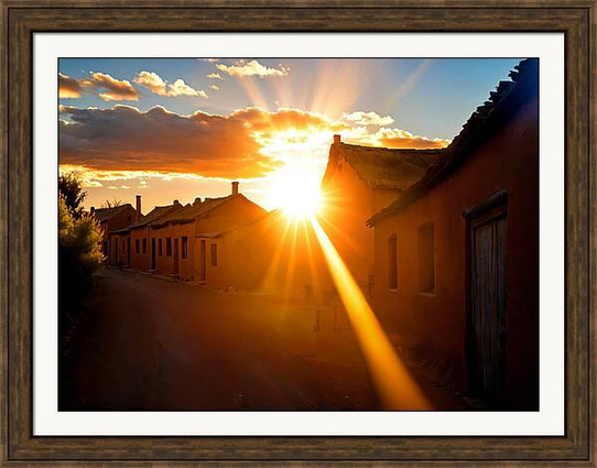 Sunshine in sunset over a village street framed print