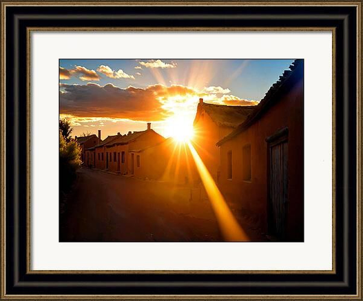 Sunshine in sunset over a village street framed print