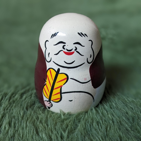 Omikuji (fortune slip) holder in the shape of the god Hotei.