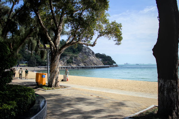 a beach view with an island in the background
