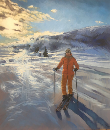 A small figure dressed in orange ski pants and puffy jacket is standing on skis, holding ski poles, in the middle of a snowy landscape, a shallow sloping tunturi (fell) in the background. There is bright sunshine coming through white clouds on the upper left, and clouds and mists of snow being kicked up around the landscape by high winds. 