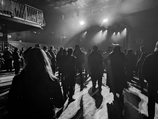 Black and white shadowy silhouette of concert attendees