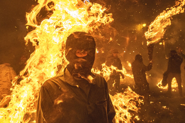 A festival participant appears almost engulfed in flames.