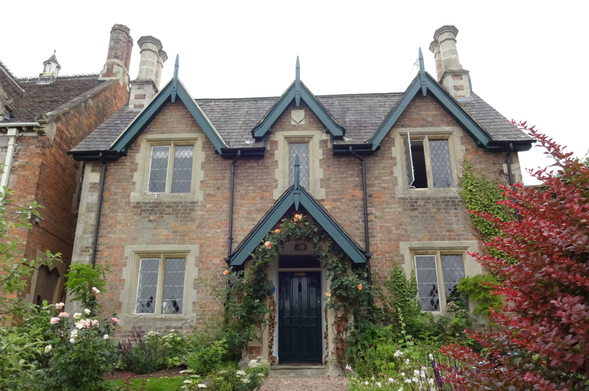 Attractive Victorian house, with roses around the door.