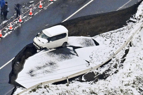 A car on a collapsed road.